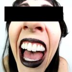 A funny fisheye video clip of an older goth woman laughing out loud.