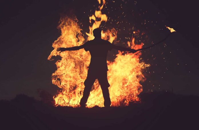 fire man burning veld fire